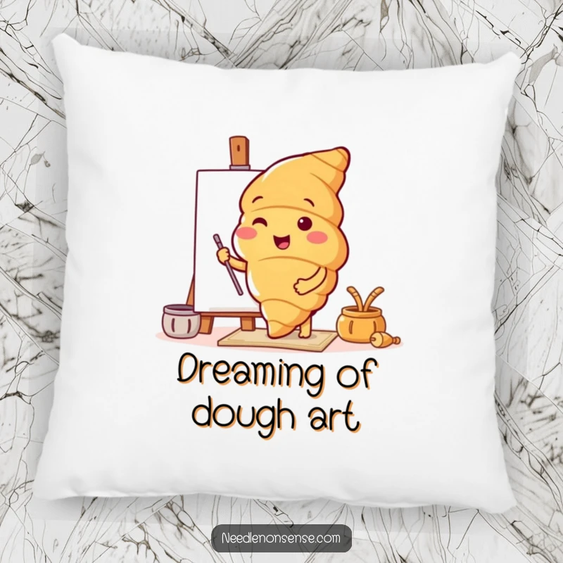 Decorative funny pillow featuring a croissant character setting up a canvas, bringing comfort and artistic cheer.
