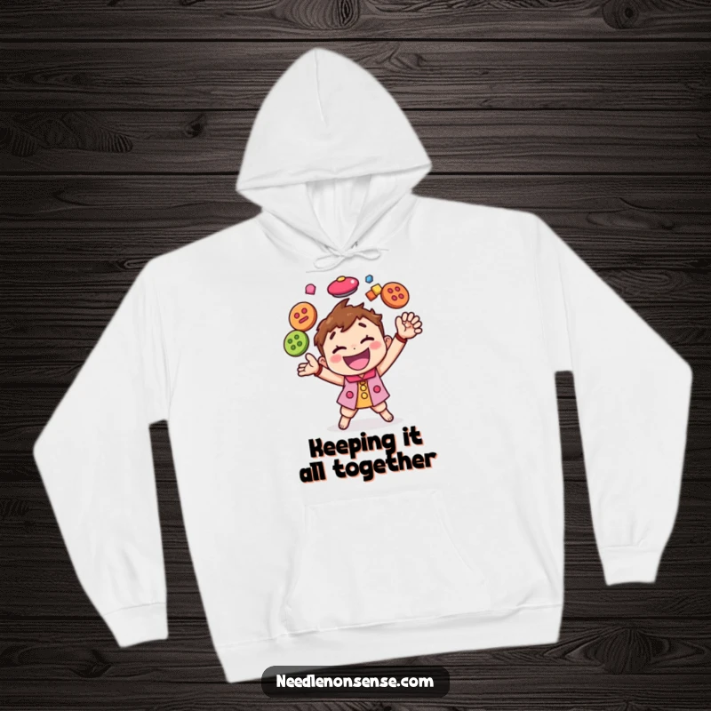 Funny hoodie depicting a happy character expertly juggling colorful buttons, providing warmth and a dose of crafting humor.