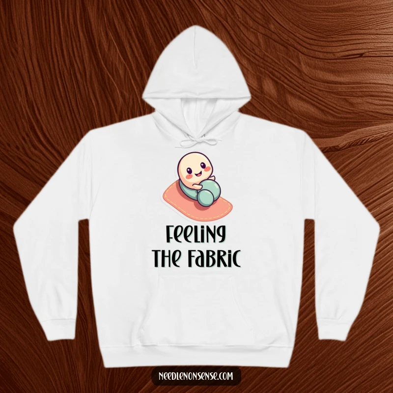 Funny button character hoodie, playfully rolling down a fabric slope, offering cozy humor and cute charm.