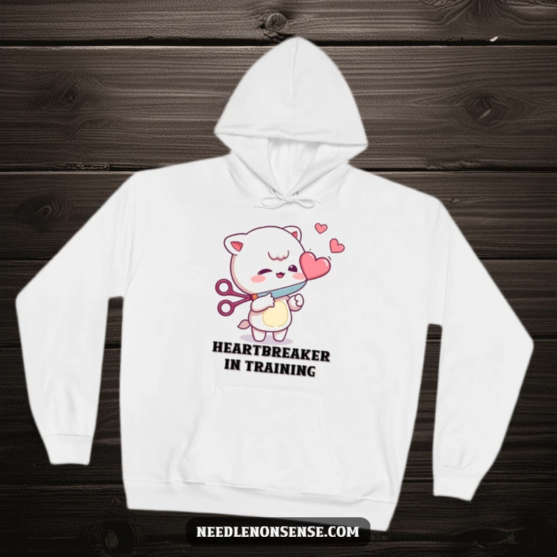 Funny Hoodie: Mischievous character playfully cutting a floating heart with scissors, designed for warmth and laughs.