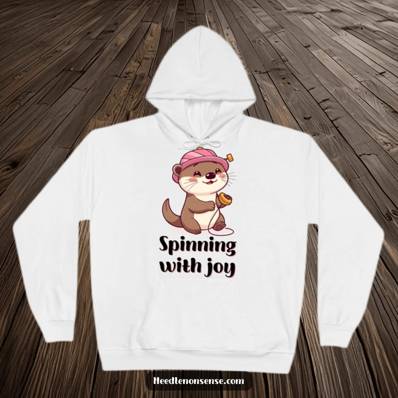 Funny Otter Sewing Hoodie, featuring a playful otter wearing a spool hat, happily spinning, embodying cozy creativity.