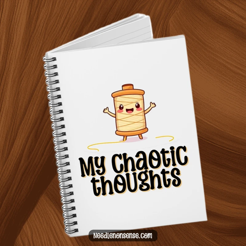 Funny thread spool character notebook, excitedly unspooling on the cover, inspiring creative journaling and note-taking.